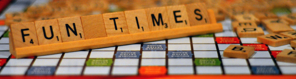 Scrabble board with tiles spelling "FUN TIMES"