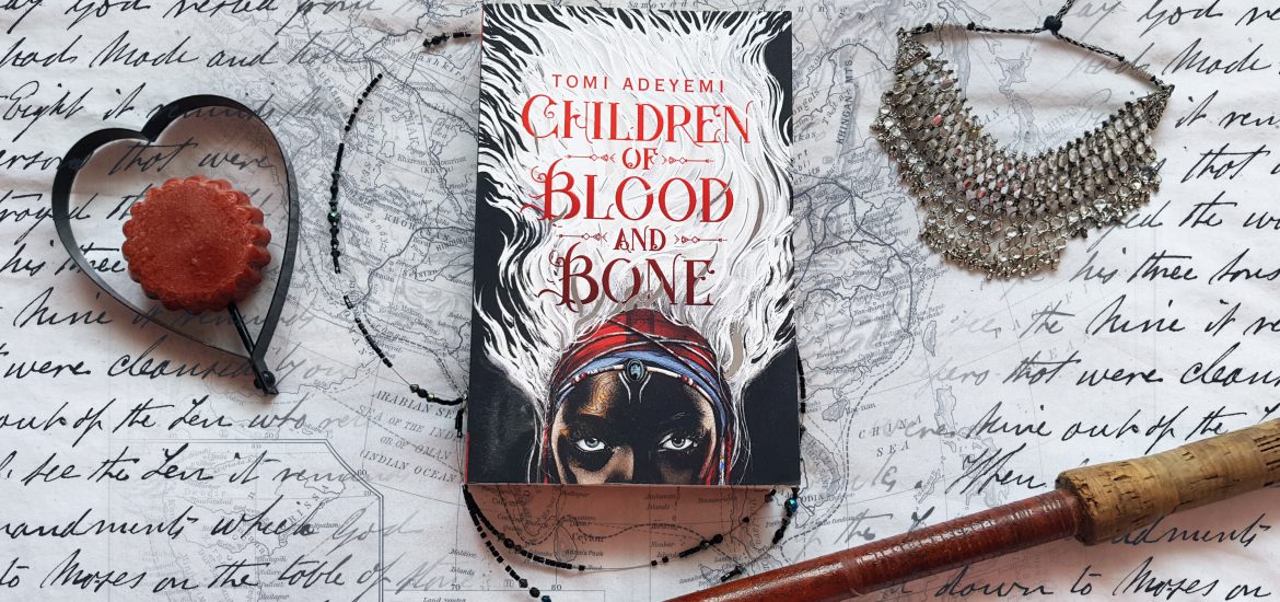 Children of Blood and Bone book with jewely, heart, old script