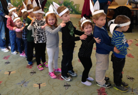 Kids doing a bunny hop dance