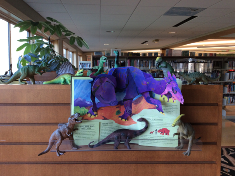 Pop-up book with toy dinosaurs