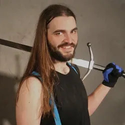 Smiling Skot Rieffer holding sword