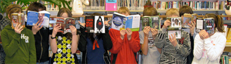 kids reading, faces hiding behind open books
