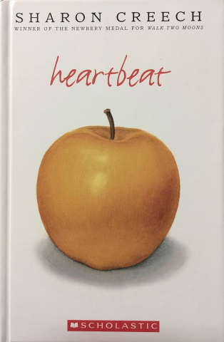 Heartbeat by Sharon Creech Photo of yellow apple on book cover