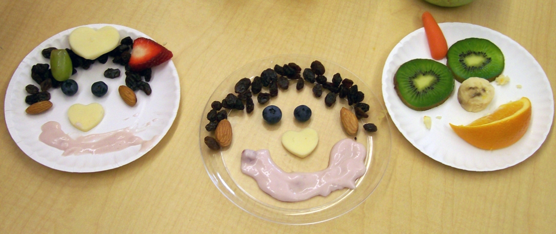 3 plates with faces created from healthy snacks